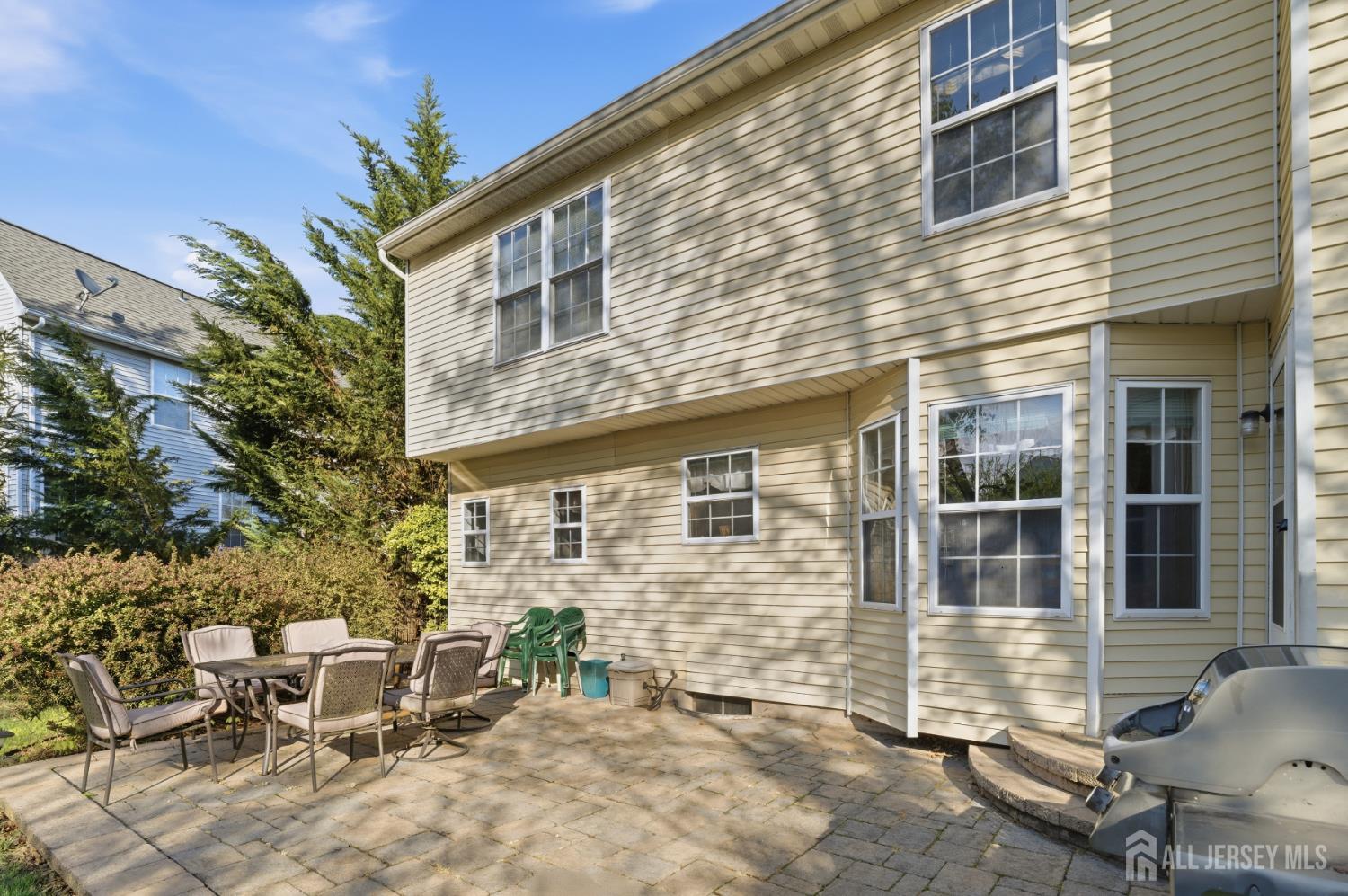 6 Shoshoni Way Somerville, NJ 08876 - Photo 42 of 52 a view of a brick house with chairs and table in a patio