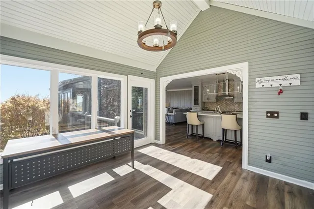 a kitchen with stainless steel appliances granite countertop a white cabinets and wooden floor