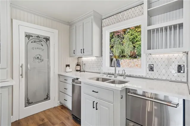 a kitchen with stainless steel appliances granite countertop a sink stove and cabinets
