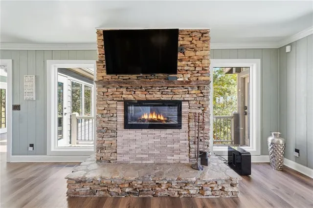 a living room with hardwood floor and a large window