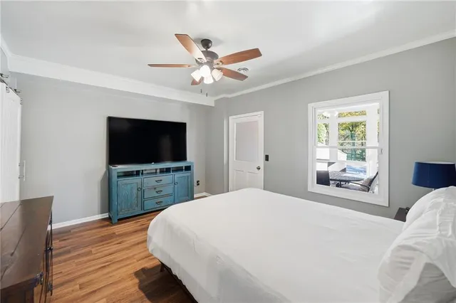 a bedroom with a large bed and a window