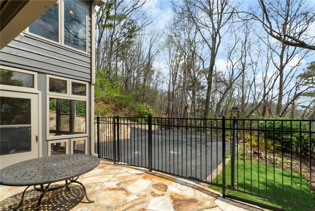 a view of a chairs and table in patio with a fireplace