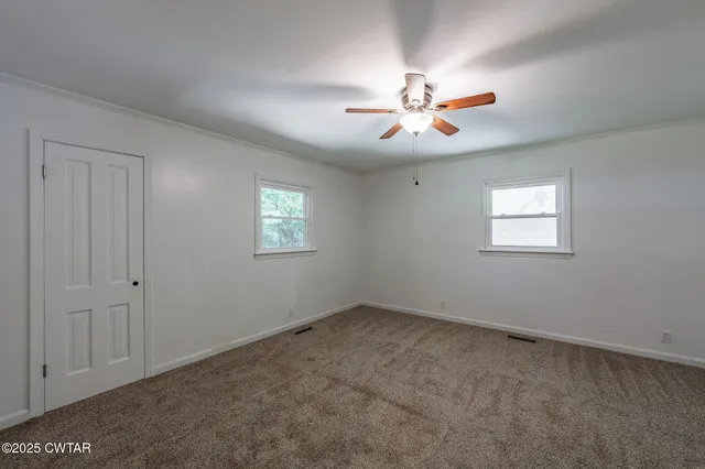 a view of an empty room with a window