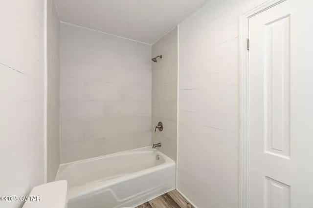 a bathroom with a bathtub and shower