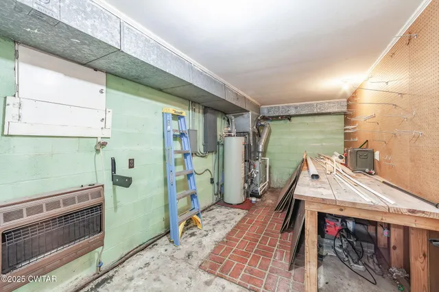 a view of a backyard with table and chairs and wooden fence