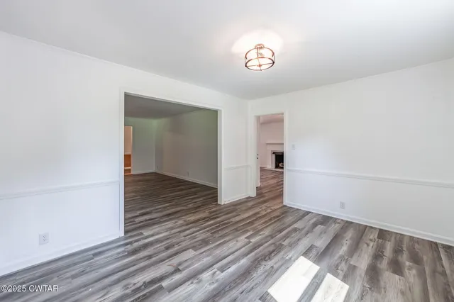 a view of a room with wooden floor