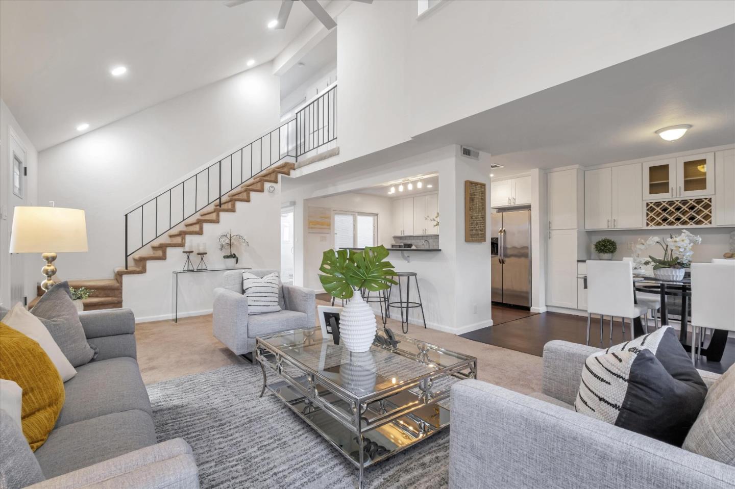 a living room with furniture fireplace and a view of kitchen