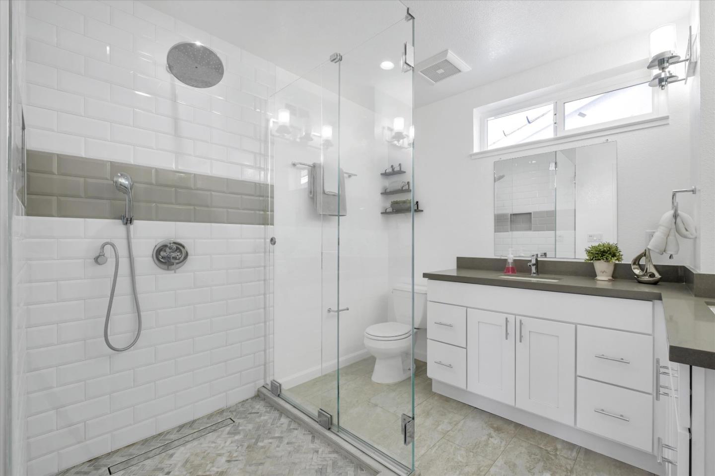 36286 Salisbury Drive Newark, CA 94560 - Photo 22 of 30 a bathroom with a double vanity sink a toilet and a shower