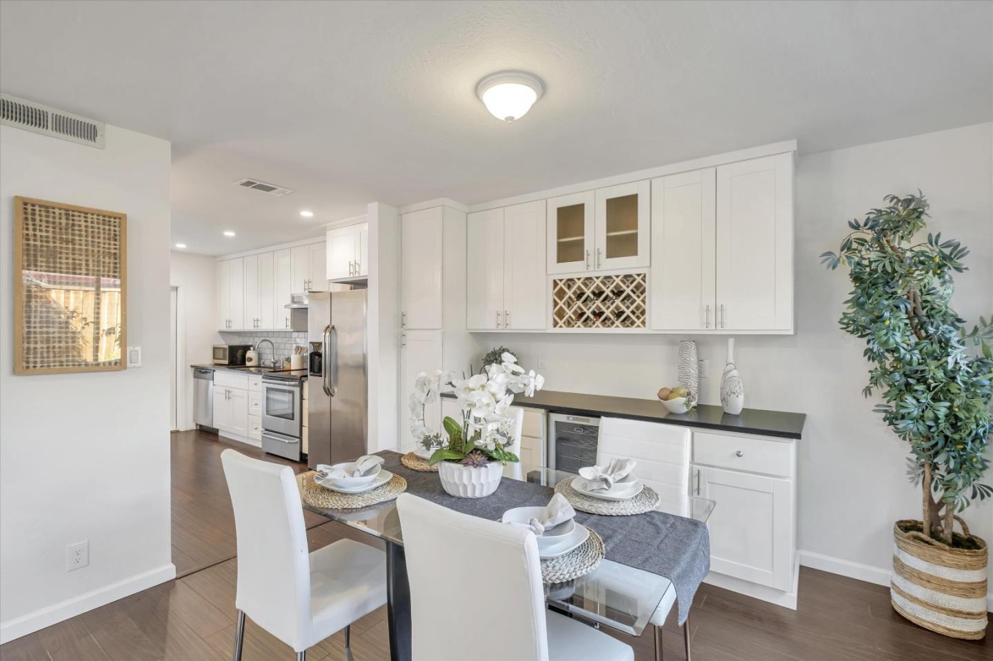 36286 Salisbury Drive Newark, CA 94560 - Photo 9 of 30 a dining room with furniture a potted plant and kitchen view