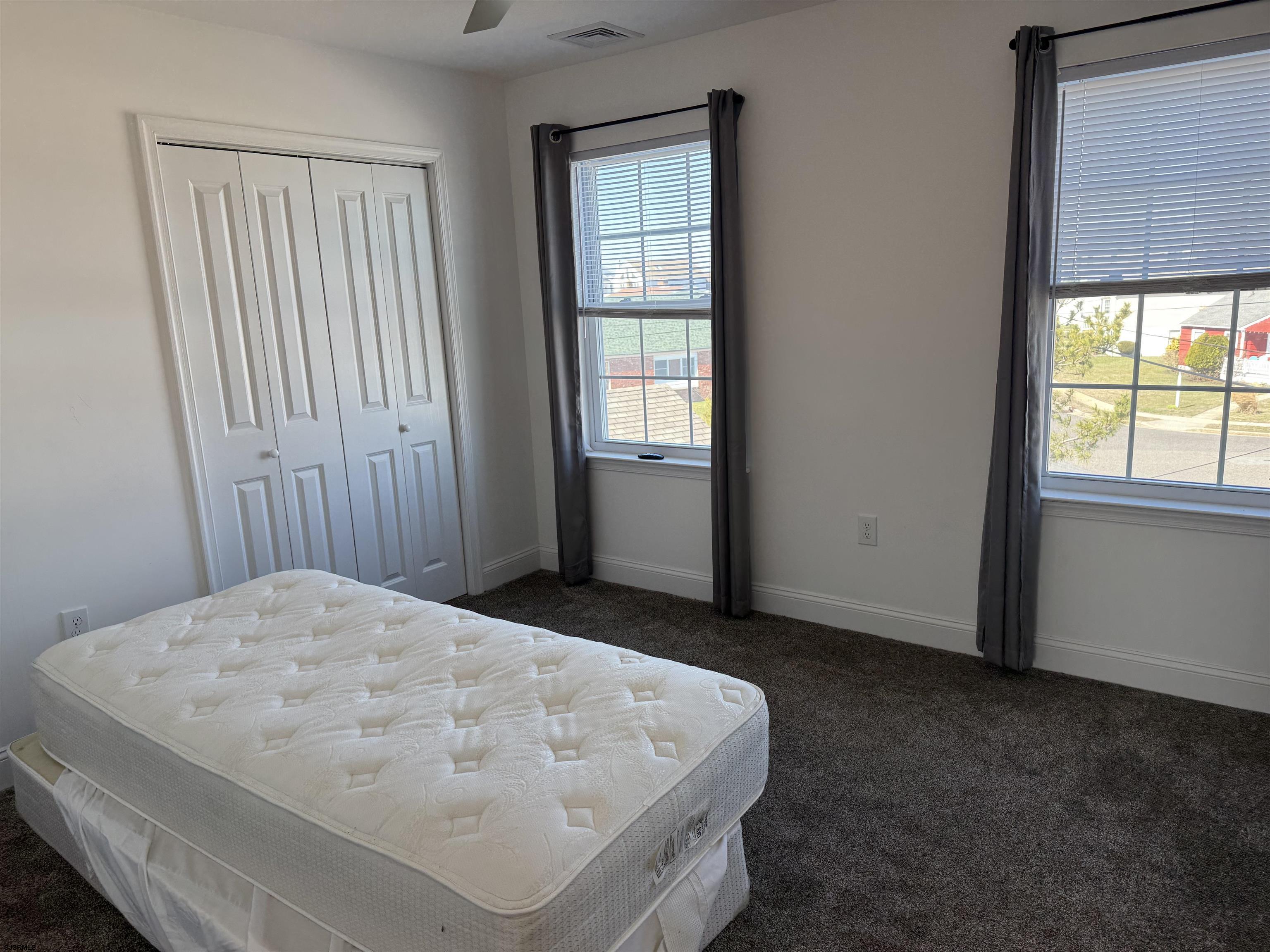 101 West Beach Avenue Brigantine, NJ 08203 - Photo 11 of 11 a bed sitting in a bedroom next to a window