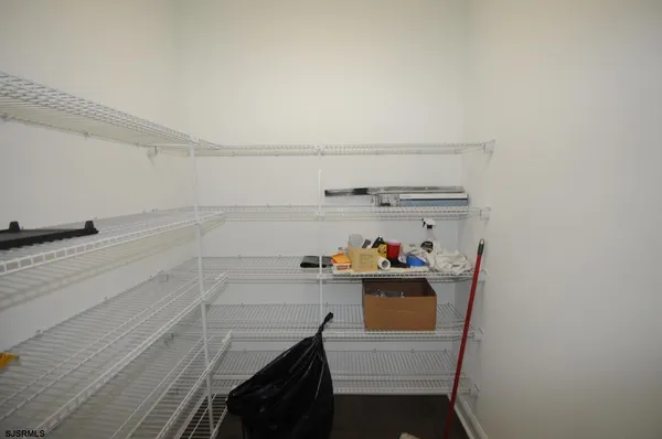 a view of storage and utility room with racks on the wall