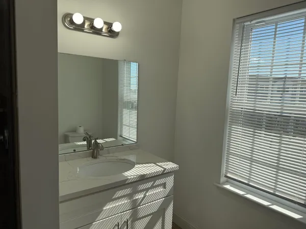 a bathroom with a sink a vanity and a mirror