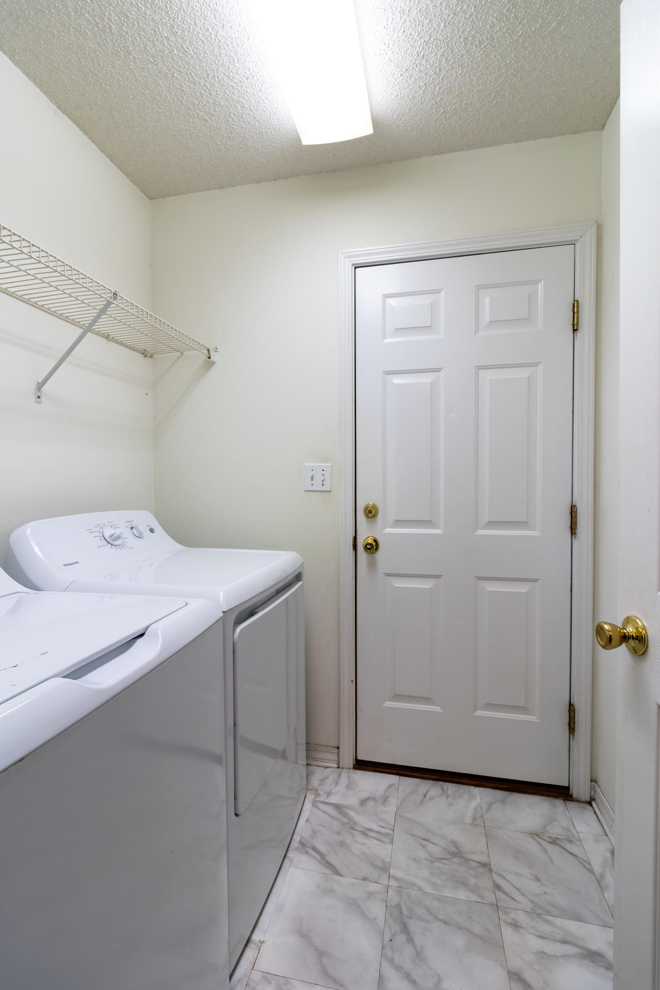 6215 Winstead Road Crestview, FL 32539 - Photo 11 of 11 a utility room with cabinets washer and dryer