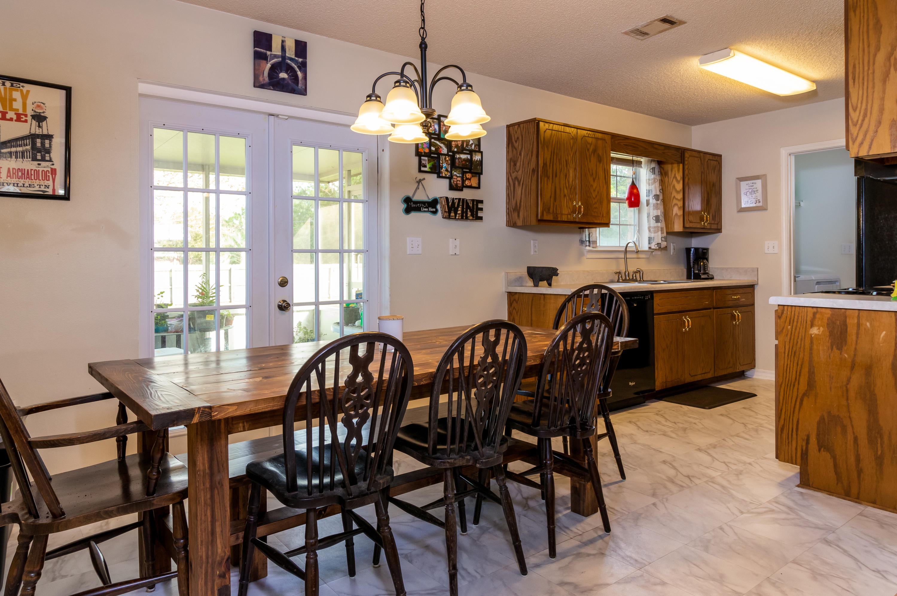 6215 Winstead Road Crestview, FL 32539 - Photo 4 of 11 a view of a dining room with furniture and chandelier