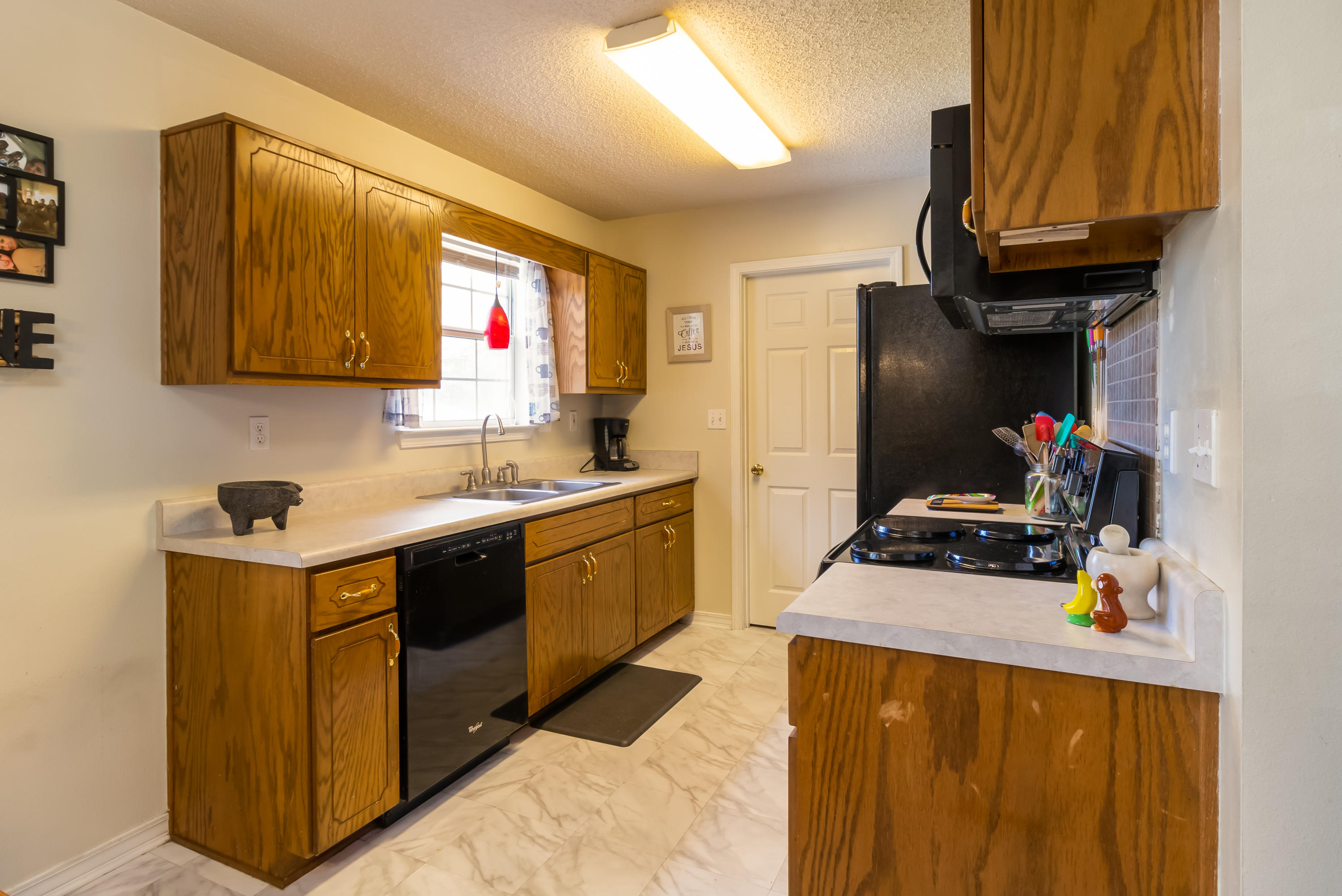 6215 Winstead Road Crestview, FL 32539 - Photo 6 of 11 a kitchen with a sink a stove and a refrigerator