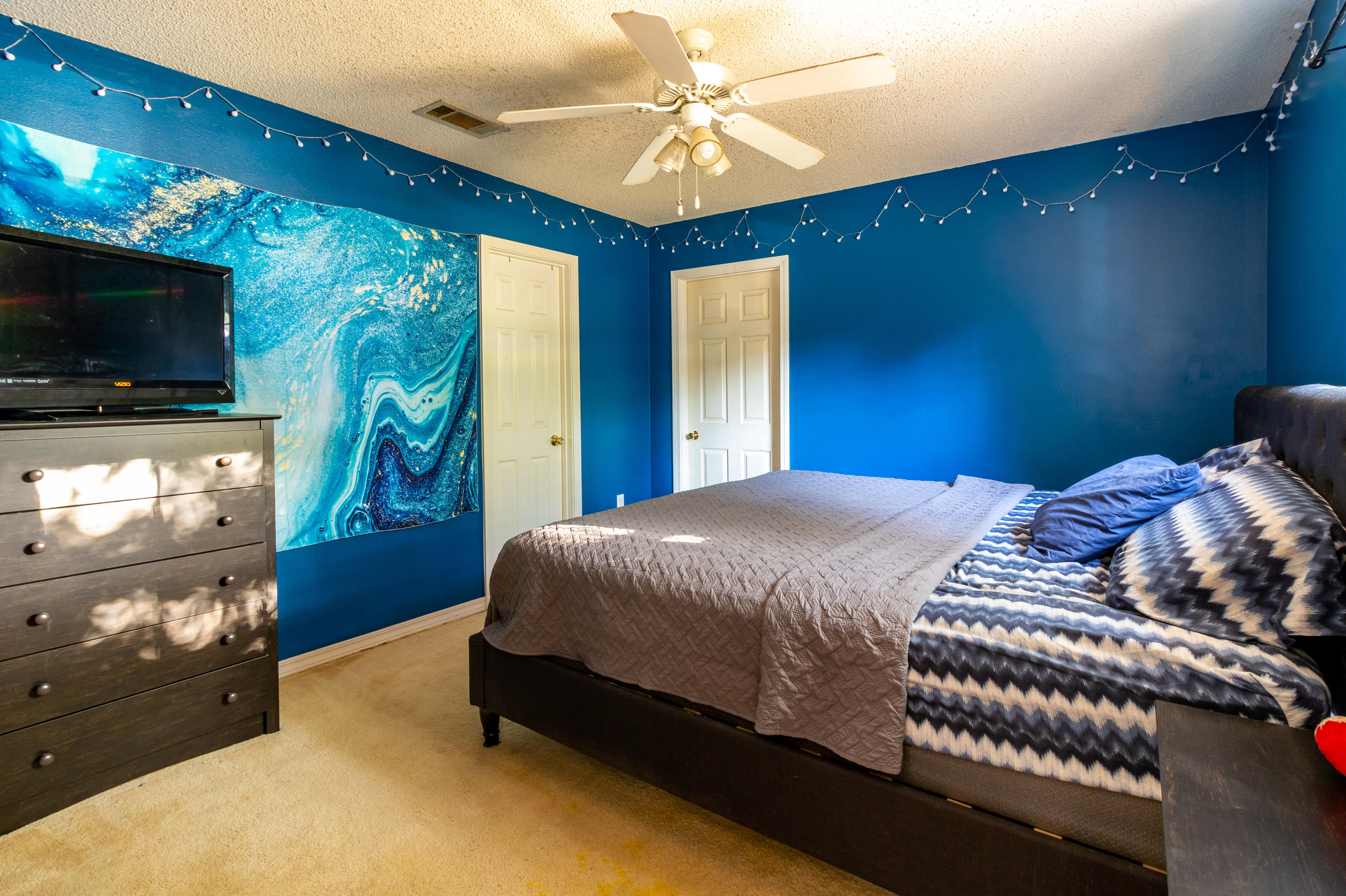 6215 Winstead Road Crestview, FL 32539 - Photo 7 of 11 a bedroom with a bed and a flat screen tv