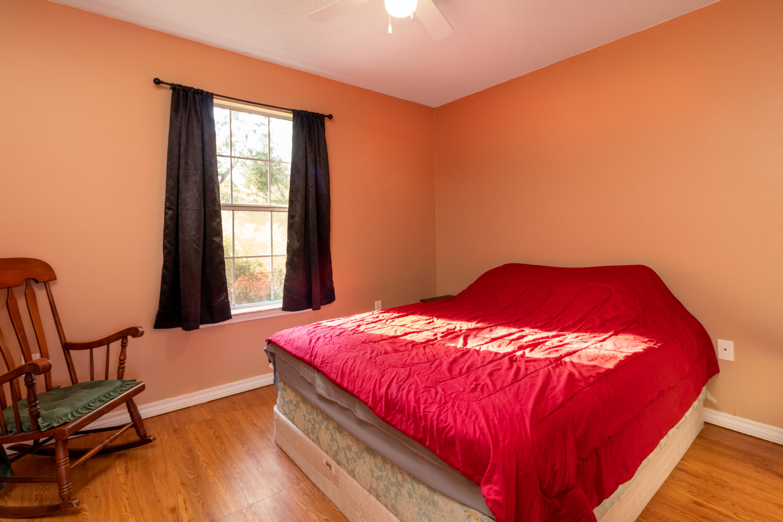 6215 Winstead Road Crestview, FL 32539 - Photo 8 of 11 a bedroom with a bed and window