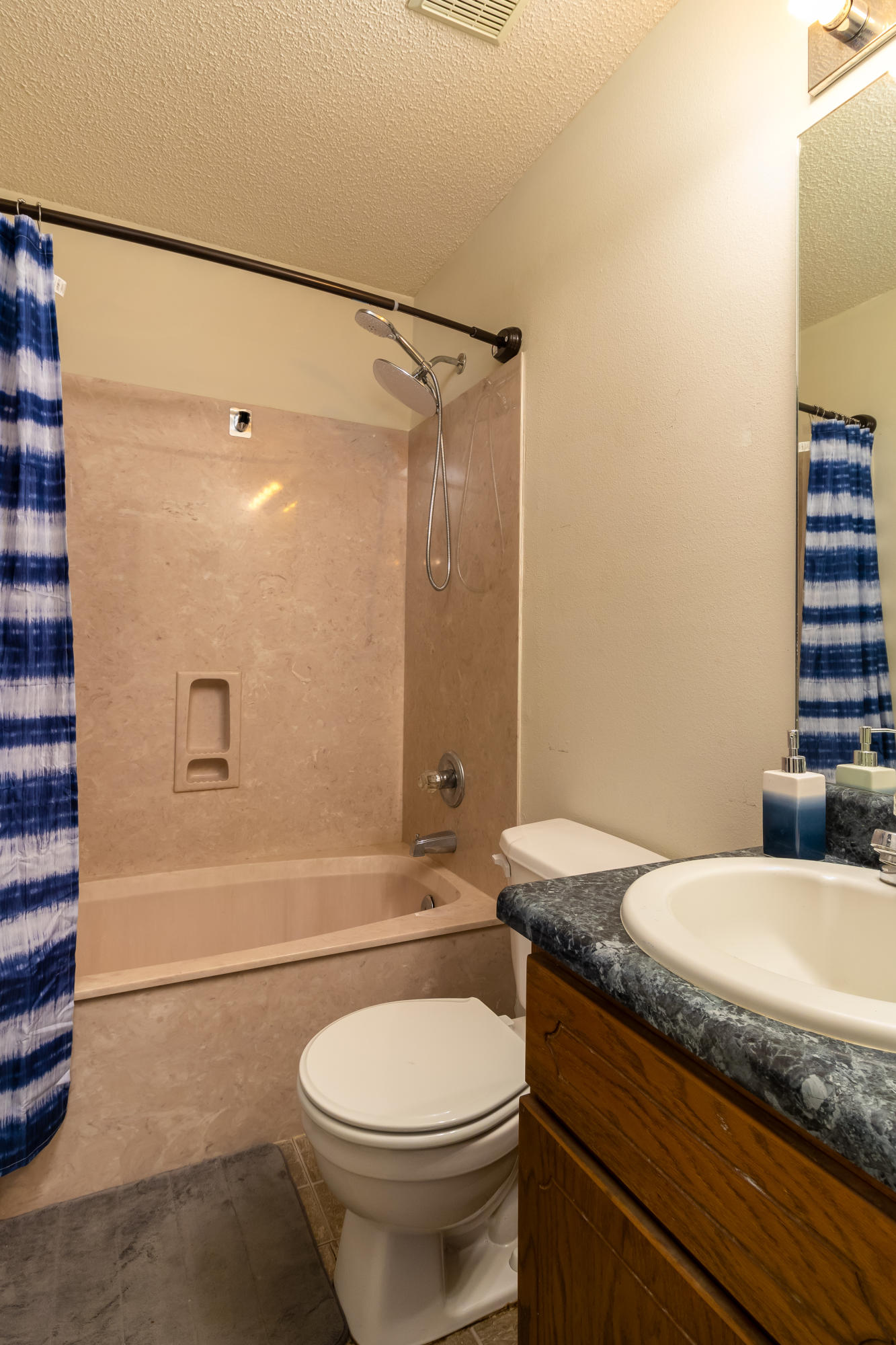 6215 Winstead Road Crestview, FL 32539 - Photo 9 of 11 a bathroom with a granite countertop toilet sink and shower