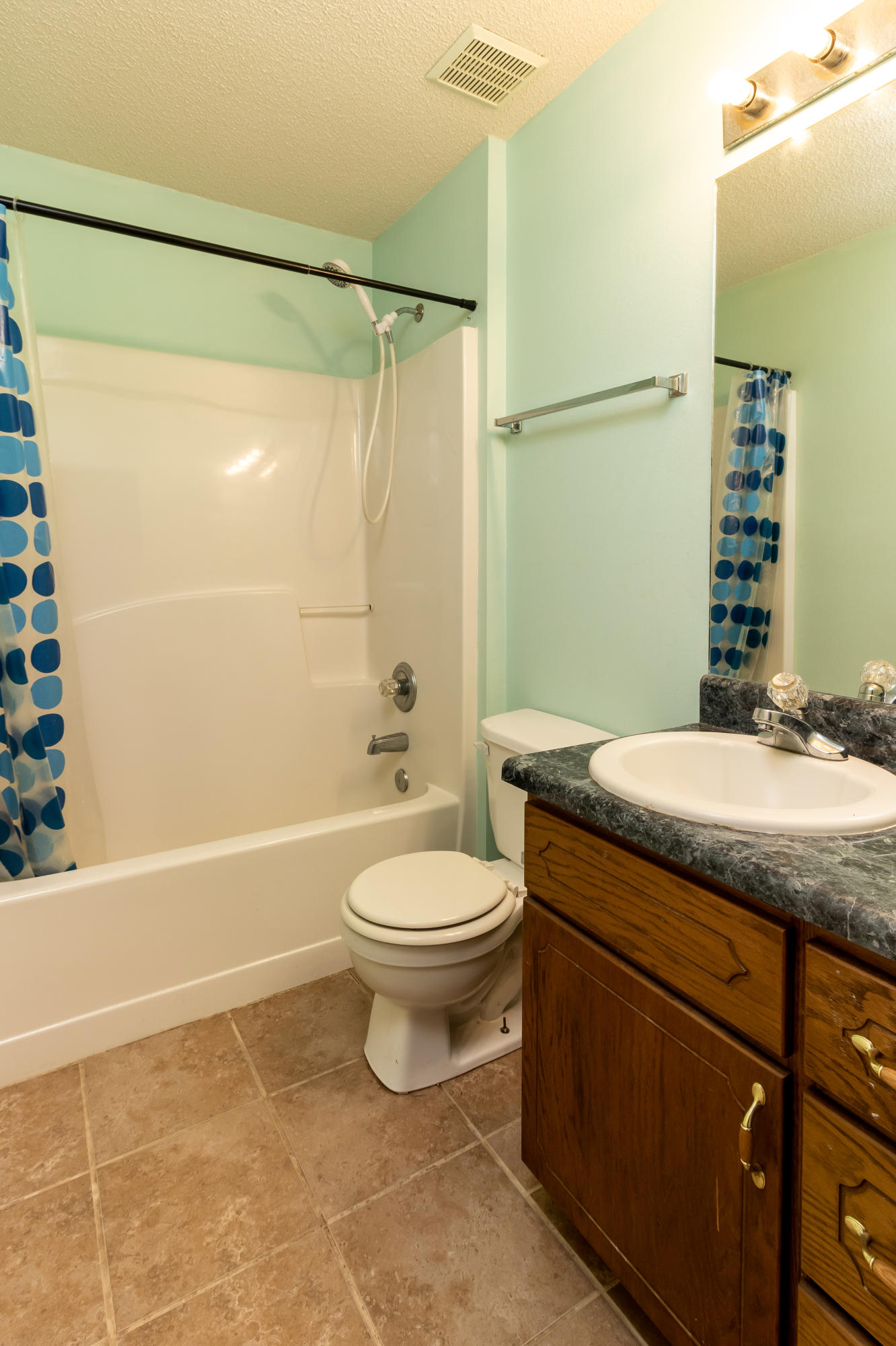 6215 Winstead Road Crestview, FL 32539 - Photo 10 of 11 a bathroom with a granite countertop sink toilet a mirror and shower