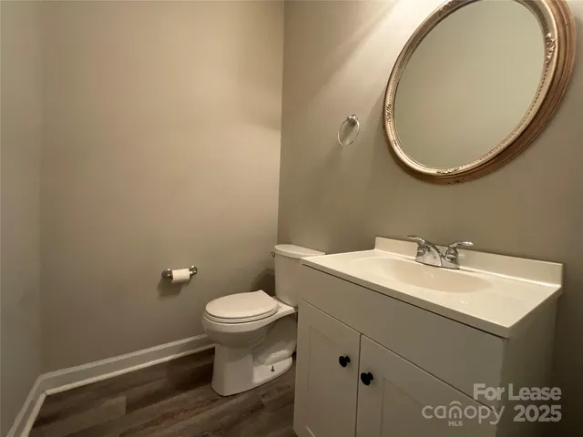 a kitchen with granite countertop white cabinets and stainless steel appliances