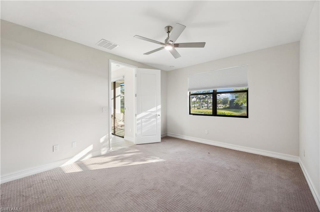 7640 Morgan Way Naples, FL 34119 - Photo 11 of 12 an empty room with wooden floor and windows