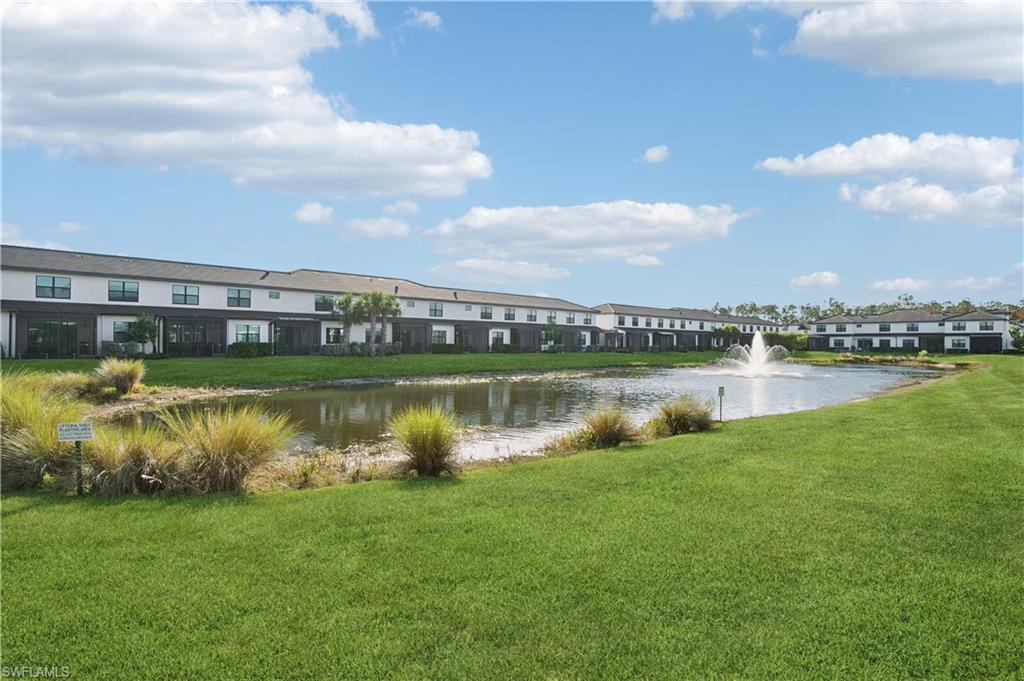 7640 Morgan Way Naples, FL 34119 - Photo 2 of 12 a view of a lake with houses in the back