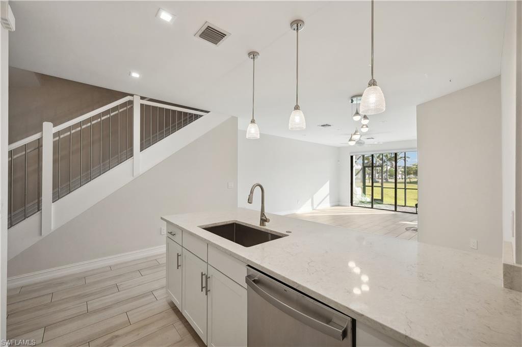 7640 Morgan Way Naples, FL 34119 - Photo 3 of 12 a kitchen with stainless steel appliances granite countertop a sink a window and a kitchen view