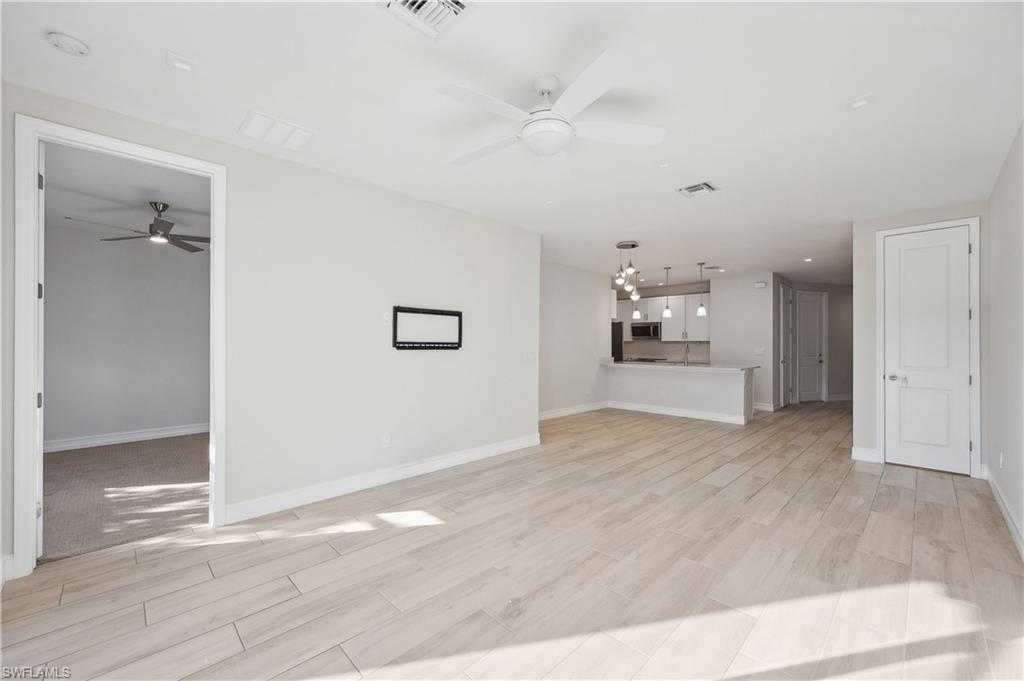 7640 Morgan Way Naples, FL 34119 - Photo 5 of 12 wooden floor in an empty room