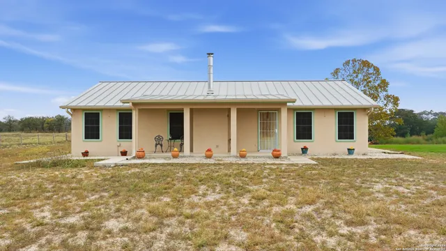 a front view of a house with a garden and yard