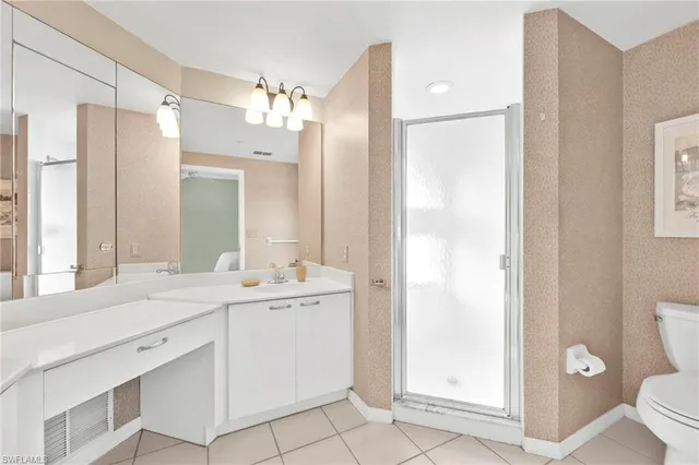 a bathroom with a double vanity sink mirror and toilet