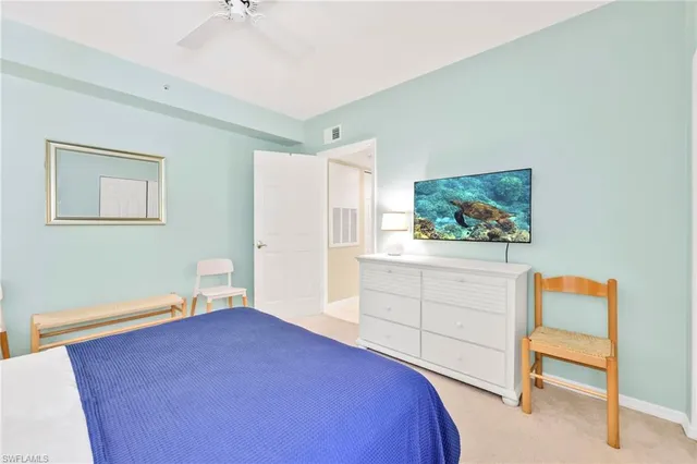 a bedroom with a bed and a dresser in it