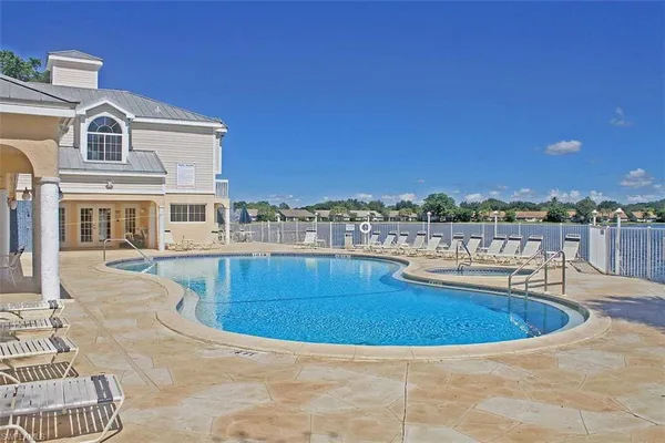 a view of a swimming pool with a lounge chair