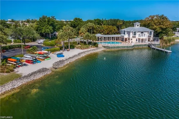 an aerial view of residential houses with outdoor space and lake view