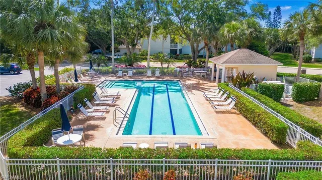 swimming pool view with a seating space