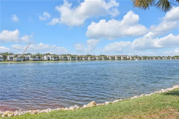 a view of a lake with houses in the back