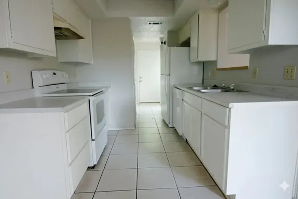 a kitchen with stainless steel appliances granite countertop a sink stove and cabinets