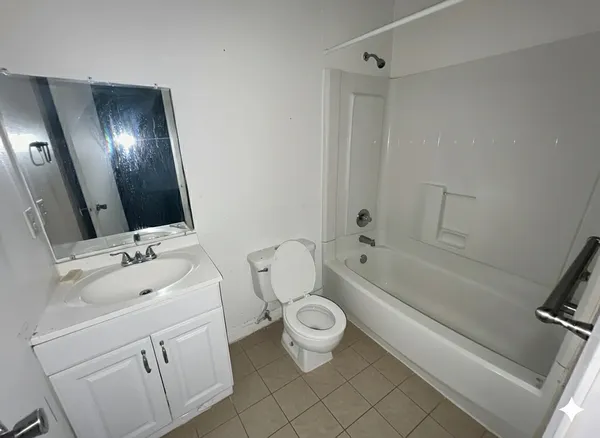 a bathroom with a sink mirror vanity and toilet