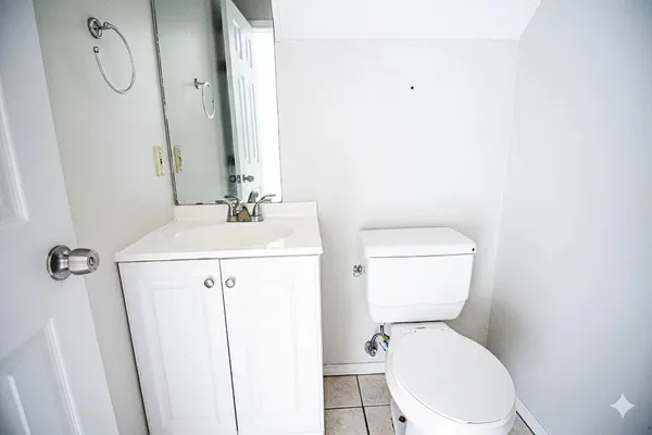 a white toilet sitting next to a bathroom sink