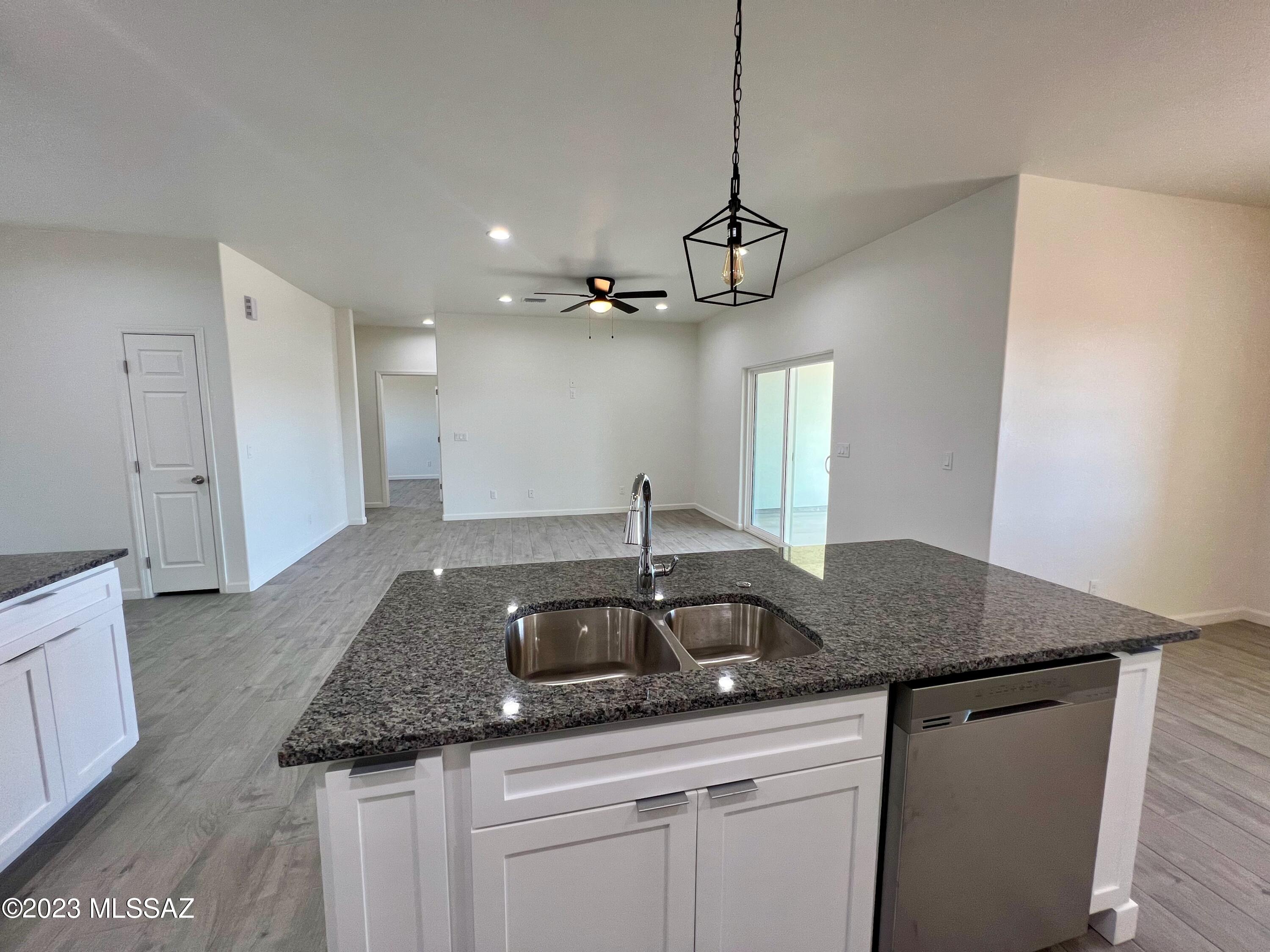 353 Dock Street Rio Rico, AZ 85648 - Photo 29 of 50 a kitchen with a sink a counter space and cabinets