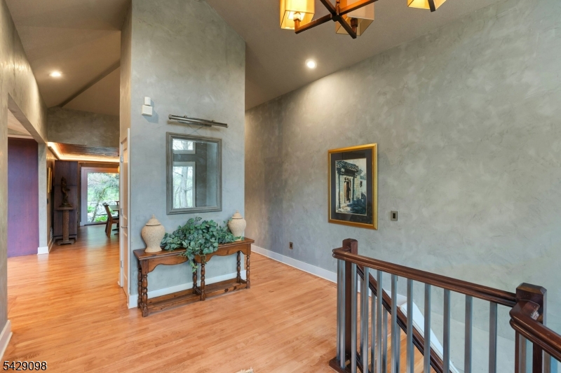 174 Bliss Road Mendham, NJ 07945 - Photo 11 of 49 a view of a hallway with wooden floor and a potted plant