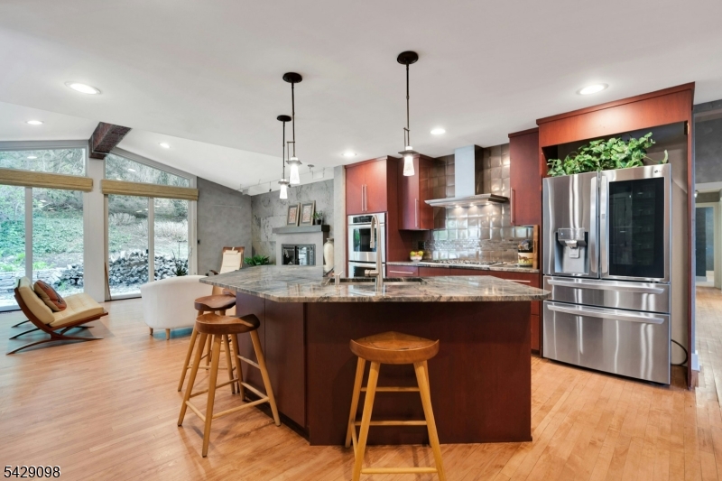 174 Bliss Road Mendham, NJ 07945 - Photo 19 of 49 a kitchen with stainless steel appliances granite countertop wooden floor window and chairs