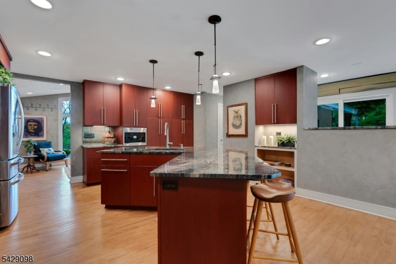 174 Bliss Road Mendham, NJ 07945 - Photo 27 of 49 a kitchen with stainless steel appliances kitchen island granite countertop a refrigerator a stove top oven and a sink with wooden floor