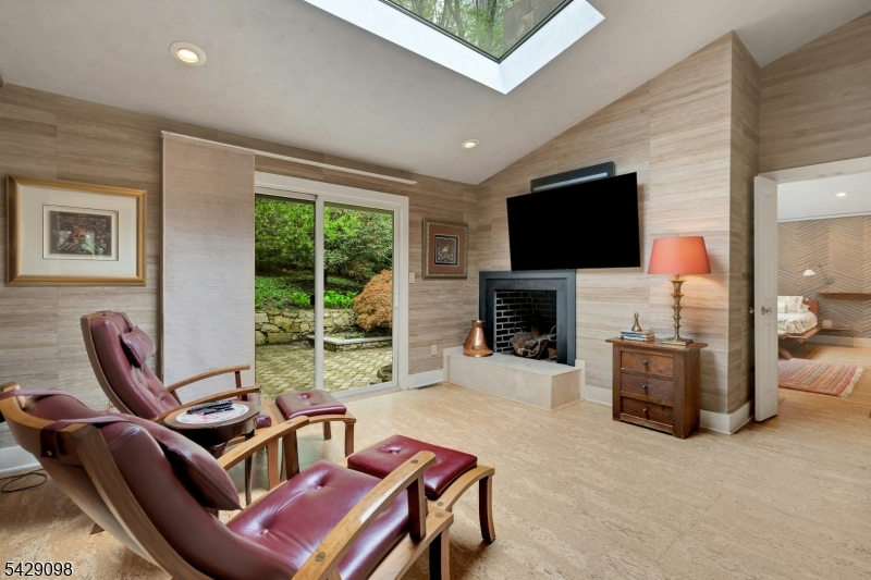 174 Bliss Road Mendham, NJ 07945 - Photo 37 of 49 a living room with furniture a flat screen tv and a fireplace