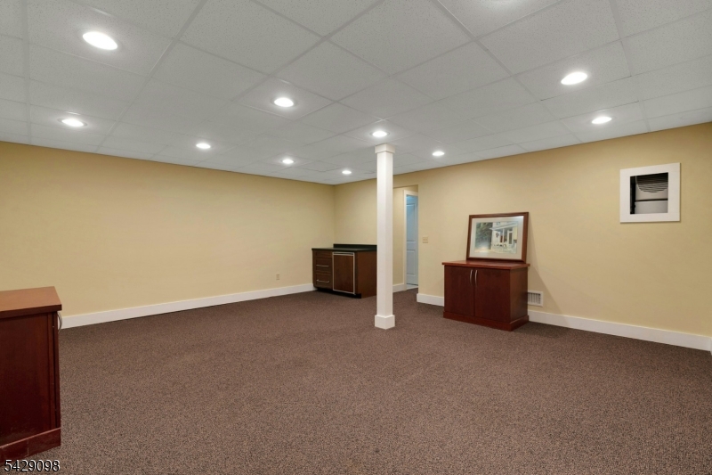 174 Bliss Road Mendham, NJ 07945 - Photo 46 of 49 an empty room with a projector and wall