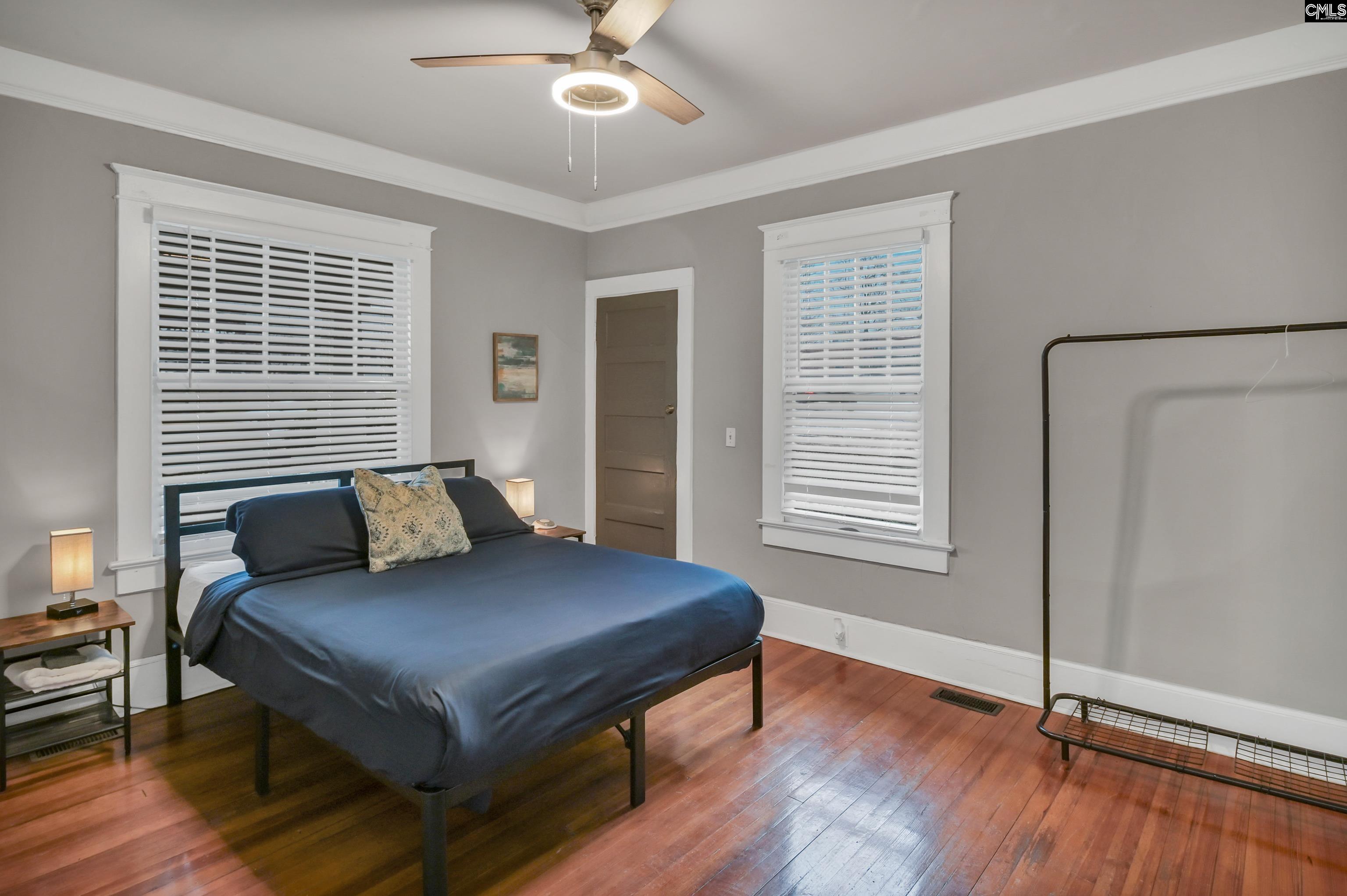 2227 Bull Street Columbia, SC 29201 - Photo 23 of 38 a bedroom with a bed and wooden floor