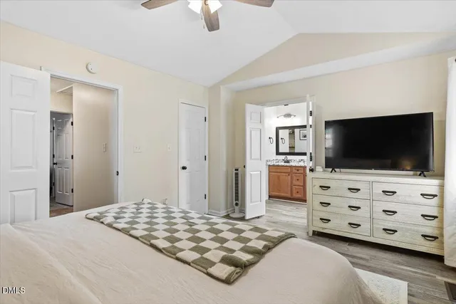 a bedroom with a bed and flat screen tv