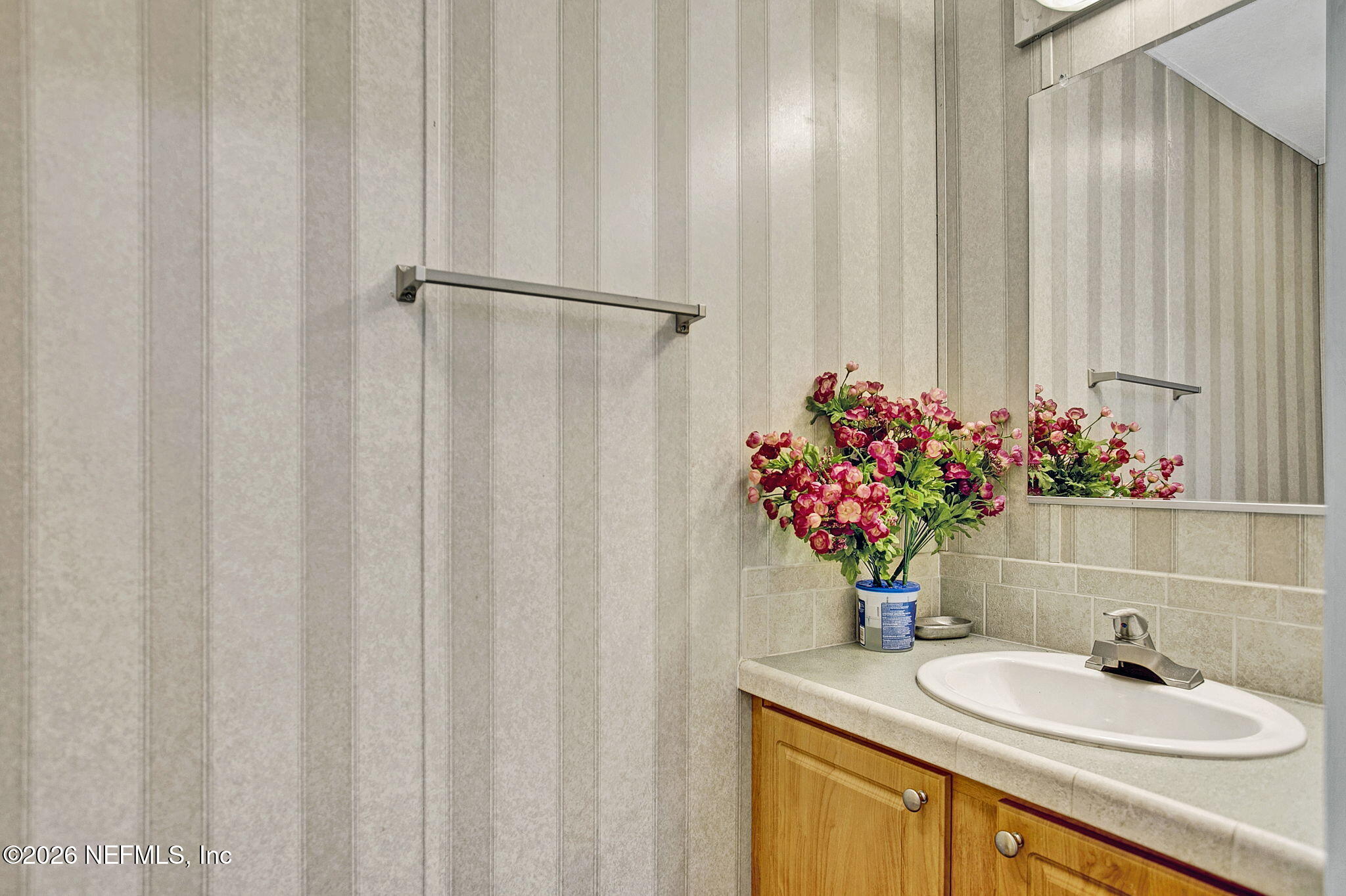 5891 Sequoia Road Keystone Heights, FL 32656 - Photo 20 of 29 a bathroom with a sink a mirror and a shower curtain