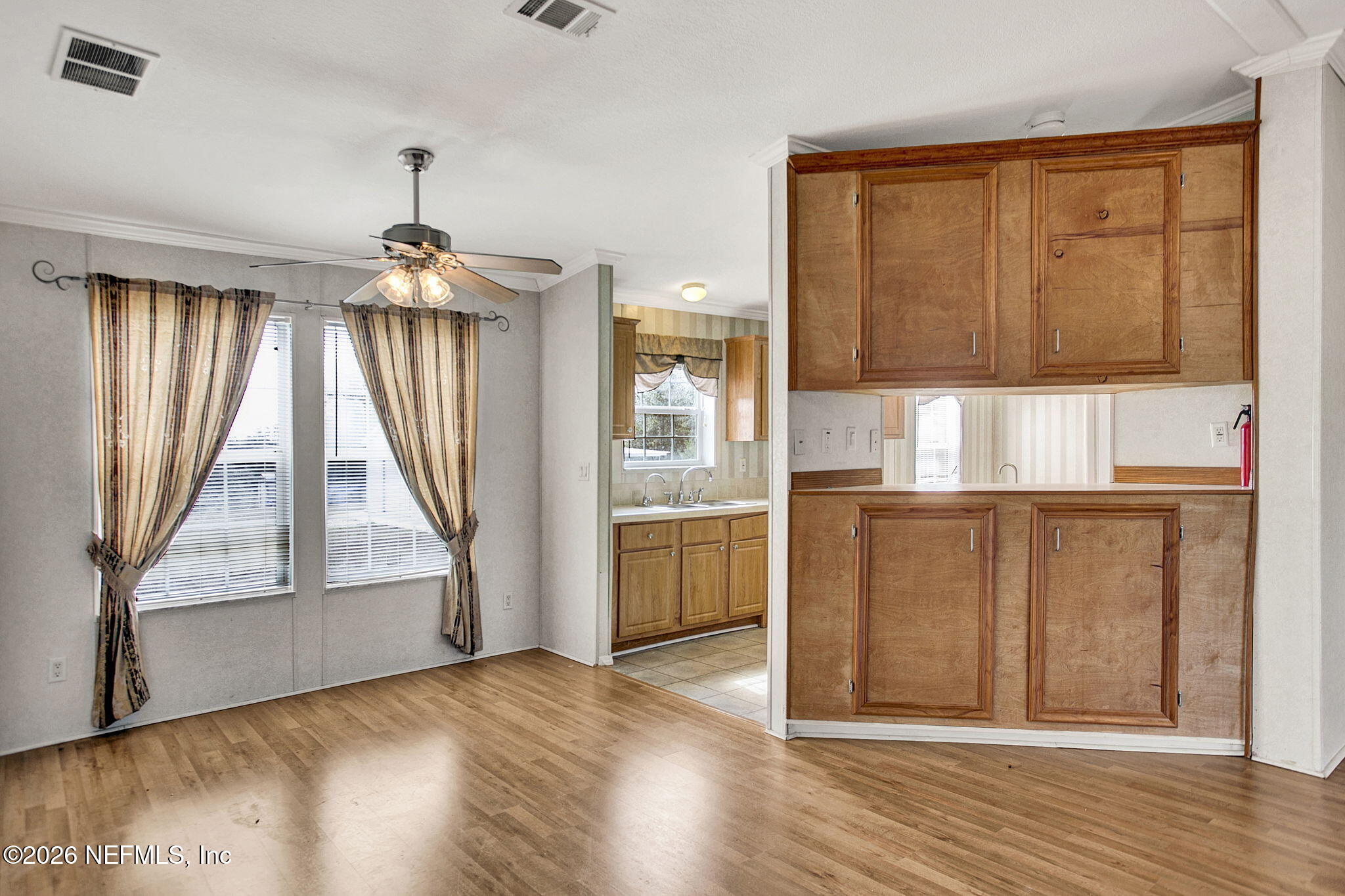 5891 Sequoia Road Keystone Heights, FL 32656 - Photo 4 of 29 an empty room with wooden floor cabinet and windows