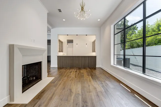 a large kitchen with stainless steel appliances a large counter space a sink dishwasher and wooden cabinets