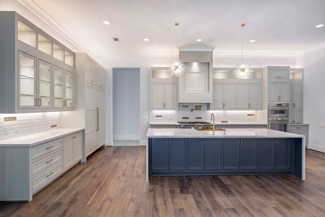 a kitchen with granite countertop white cabinets and a window
